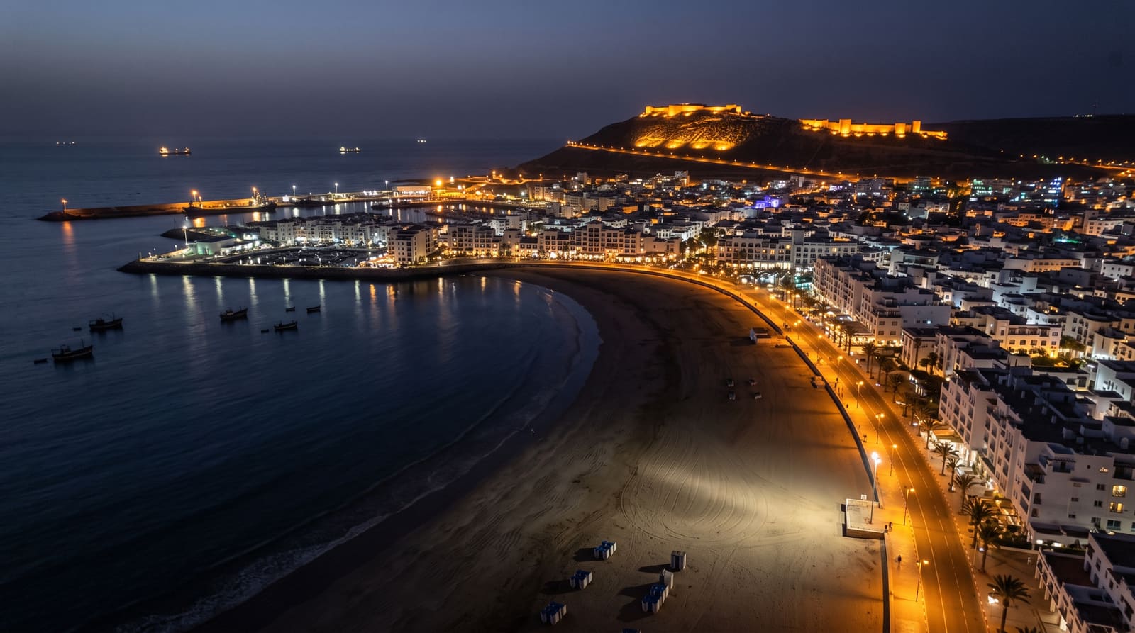 An empty stretch of Agadir beach during shoulder season, when a Teefun-planned trip can find lower prices without losing good weather.