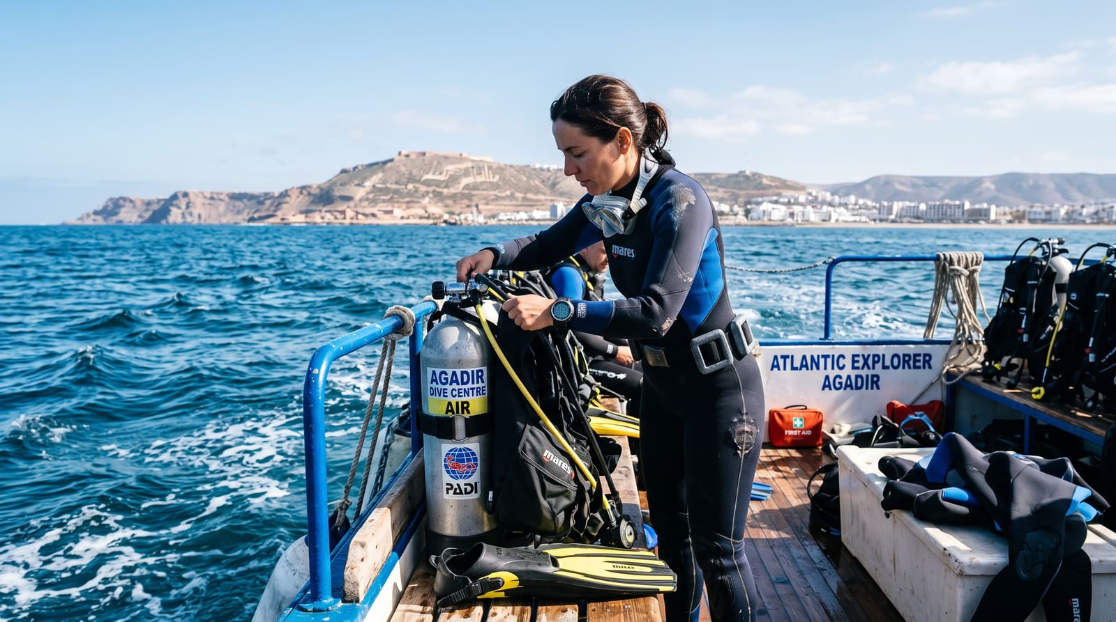 A diver preparing gear on a boat off the Agadir coast, part of an honest look at water sports a Teefun-planned trip might include.